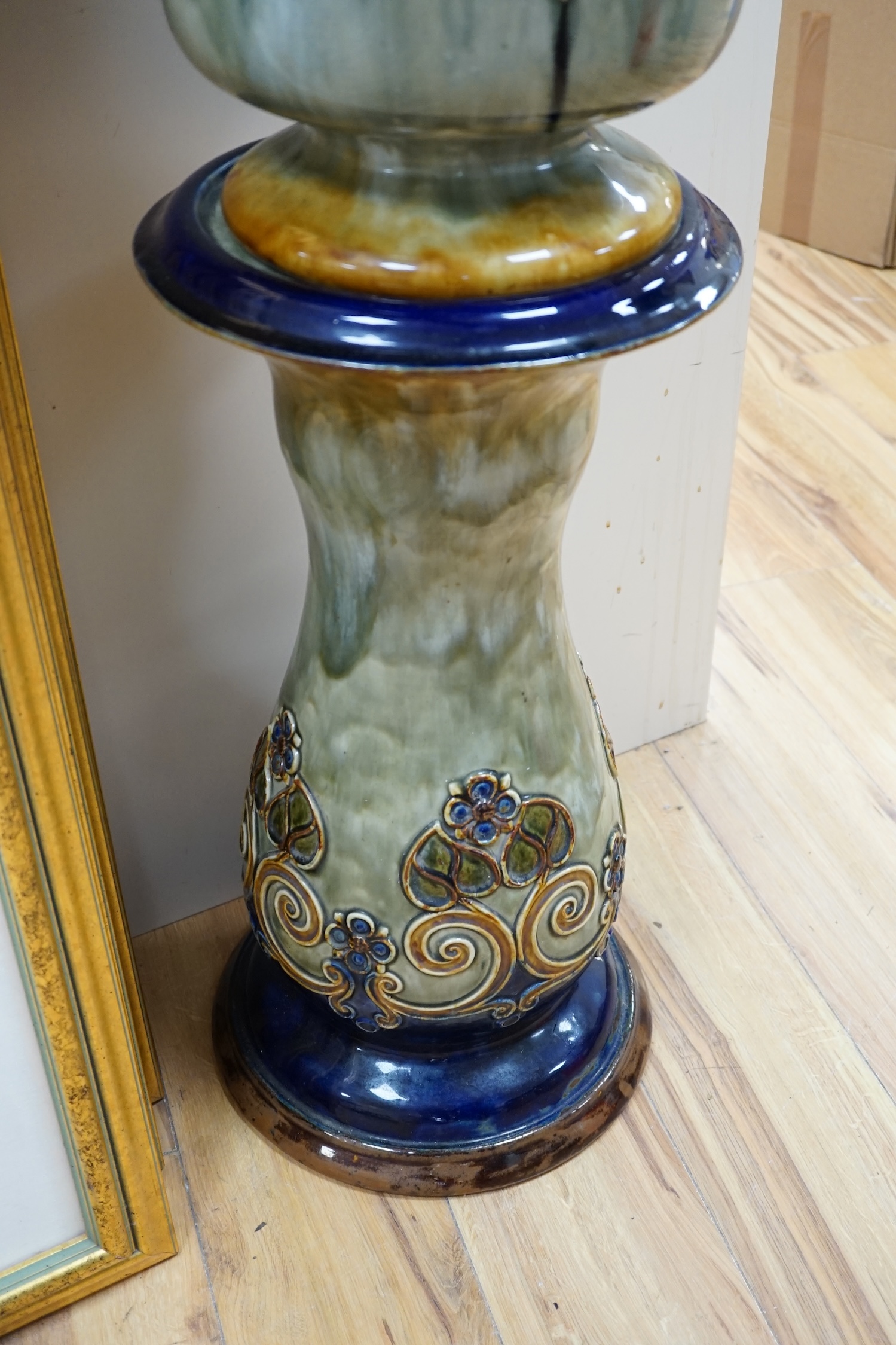 A Royal Doulton jardiniere on stand, 93cm high. Condition - poor